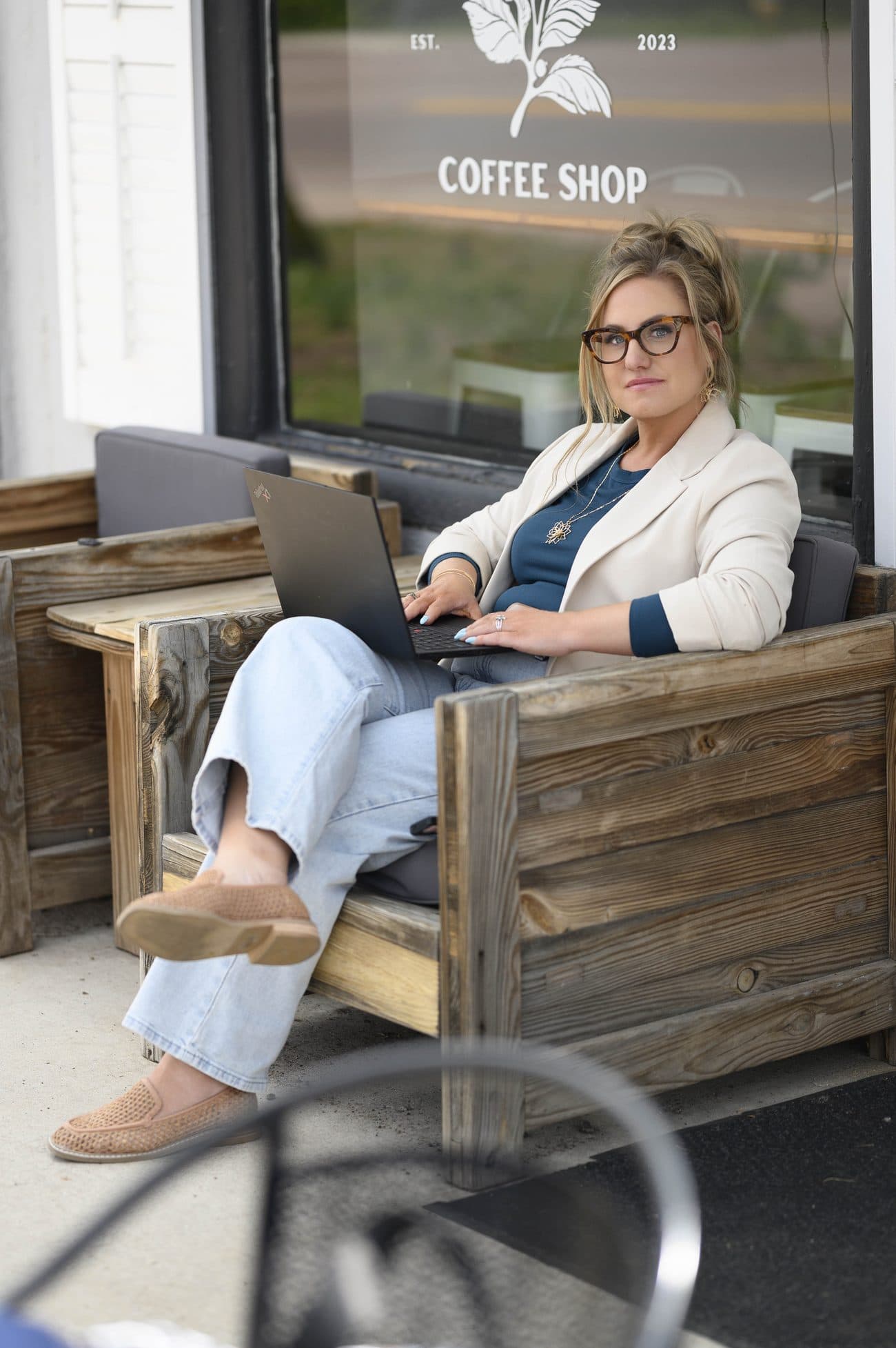 Jen, a senior social media consultant, poised in a cream blazer, ready to partner with established business owners