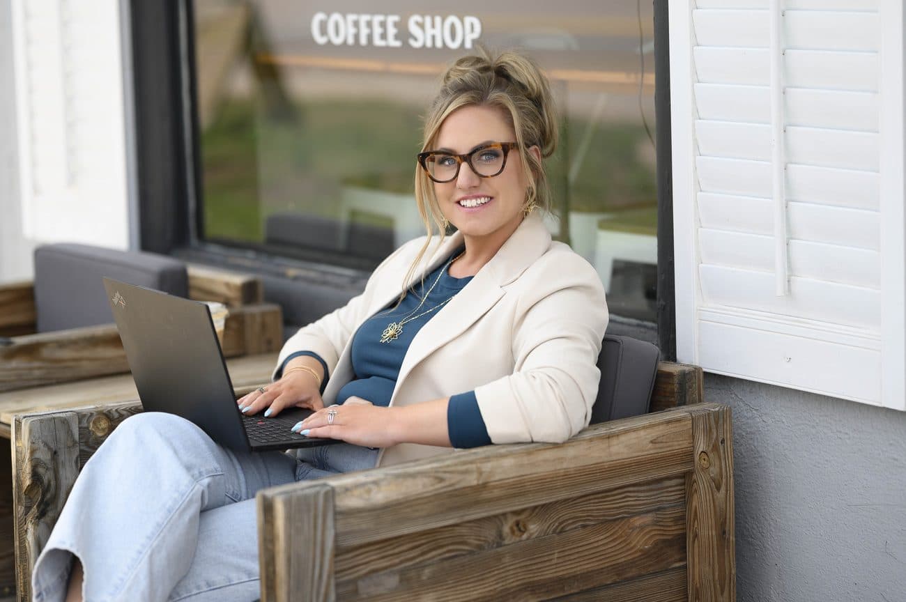 Jen smiling warmly in a cream blazer, a strategic partner for established owners who are scaling